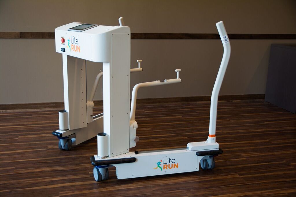 The Lite Run Mobility Trainer by itself in a room showing the base spread